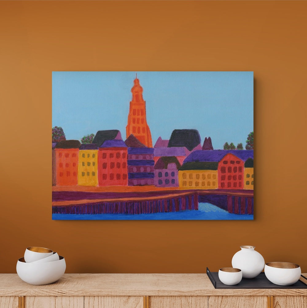Fine art print of IJsselkade in Zutphen displayed in a stylish interior with a warm brown wall, a wooden table. Colourful Dutch cityscape by Nelleke Bruno.
