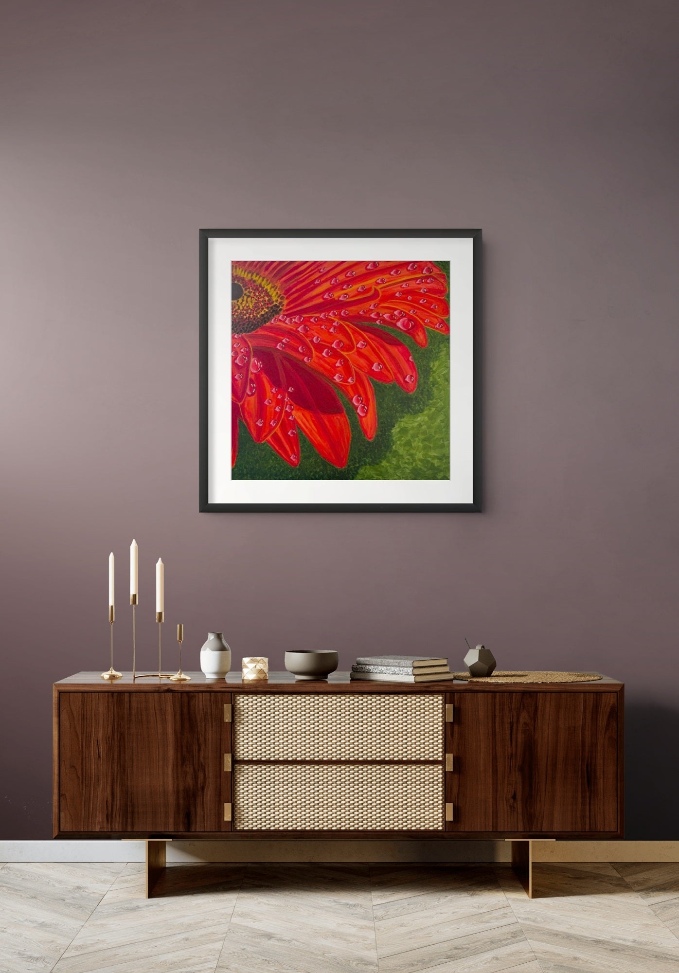 Éclat des Gerberas floral fine art print by Nelleke Bruno displayed above a brown sideboard on a warm brown wall with a black frame and white mat board, bringing colourful botanical elegance to a contemporary interior.