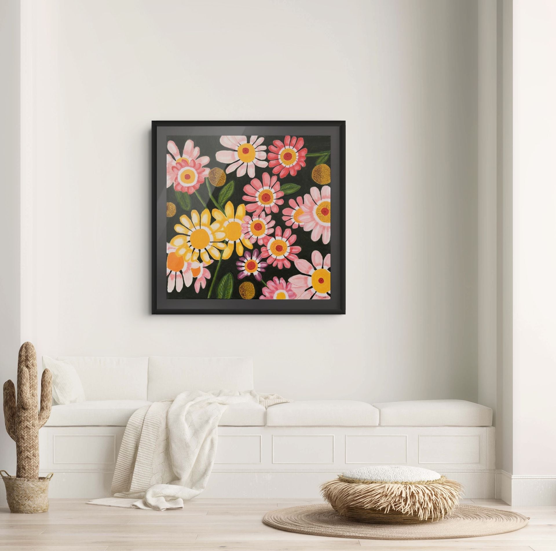 Éclat des Marguerites floral fine art print by Nelleke Bruno displayed above a white sofa against a white wall with a black frame and black passe-partout.