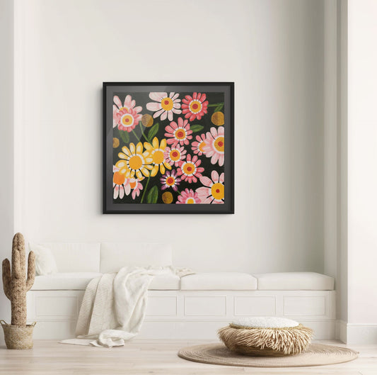 Éclat des Marguerites floral fine art print by Nelleke Bruno displayed above a white sofa against a white wall with a black frame and black passe-partout.